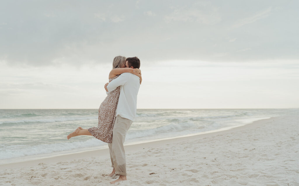 couple smiling on folly beach for seaside fl engagement photos