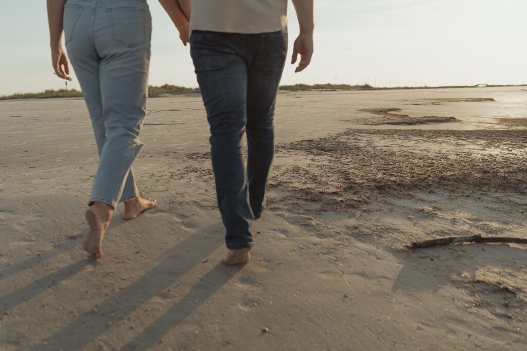 couple walking on the beach in South Carolina engagement session