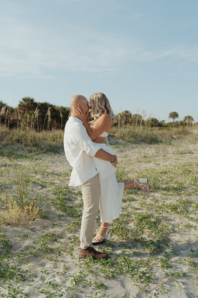 couple kissing beach engagement session in South Carolina