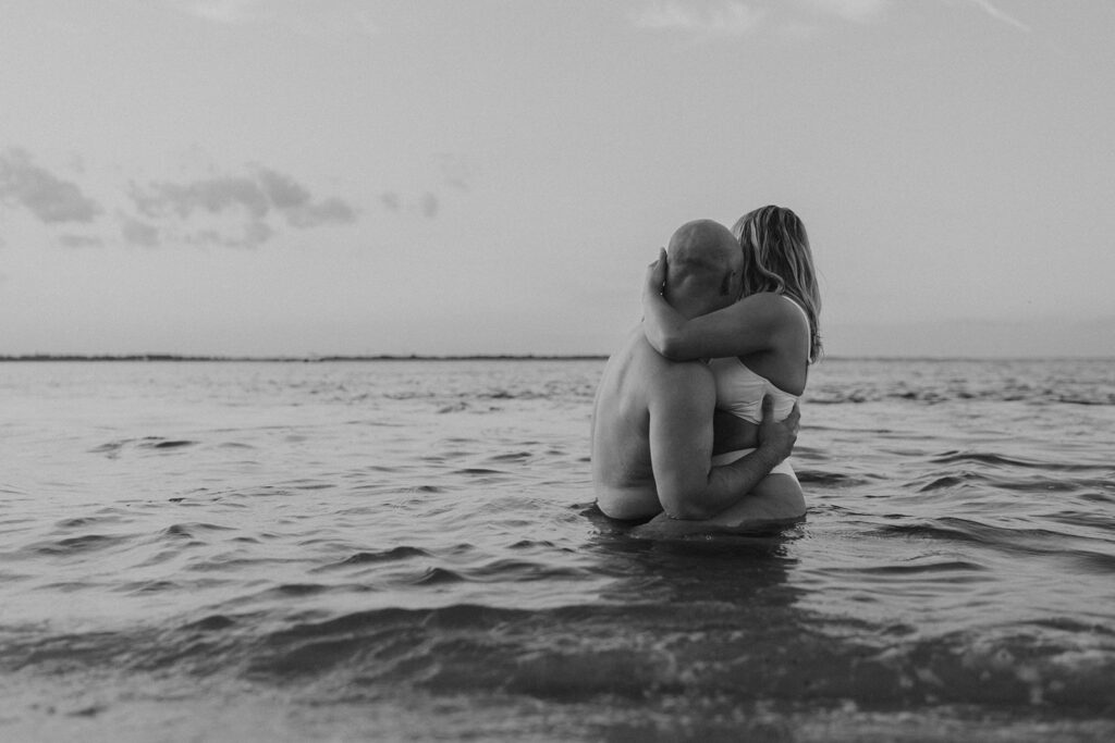 black and white beach couple photos in the ocean