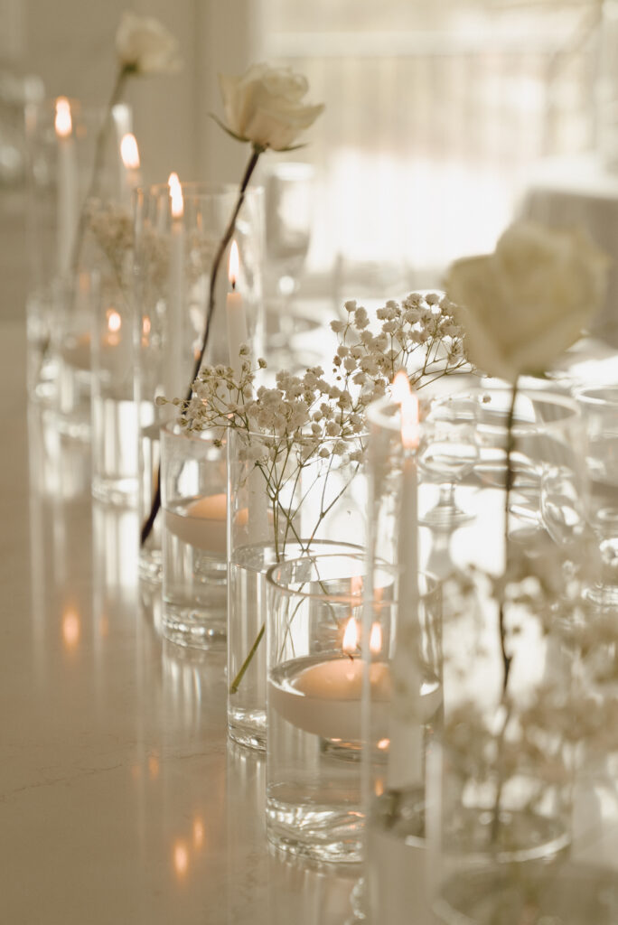 white elegant wedding florals and candle tablescape