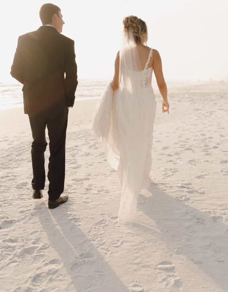 bride and groom walking on beach in 30A