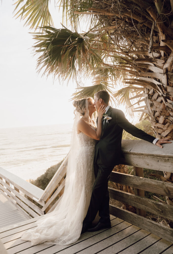 bride and groom kissing by the beach in Santa Rosa Beach, Florida