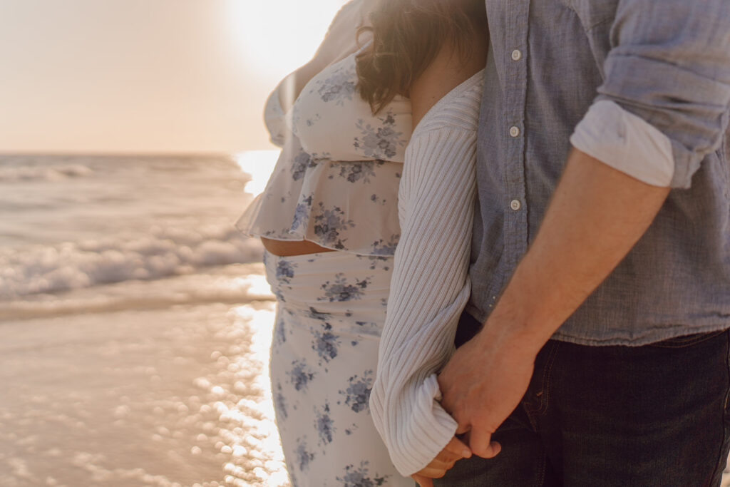 maternity session on the beach in florida during golden hour