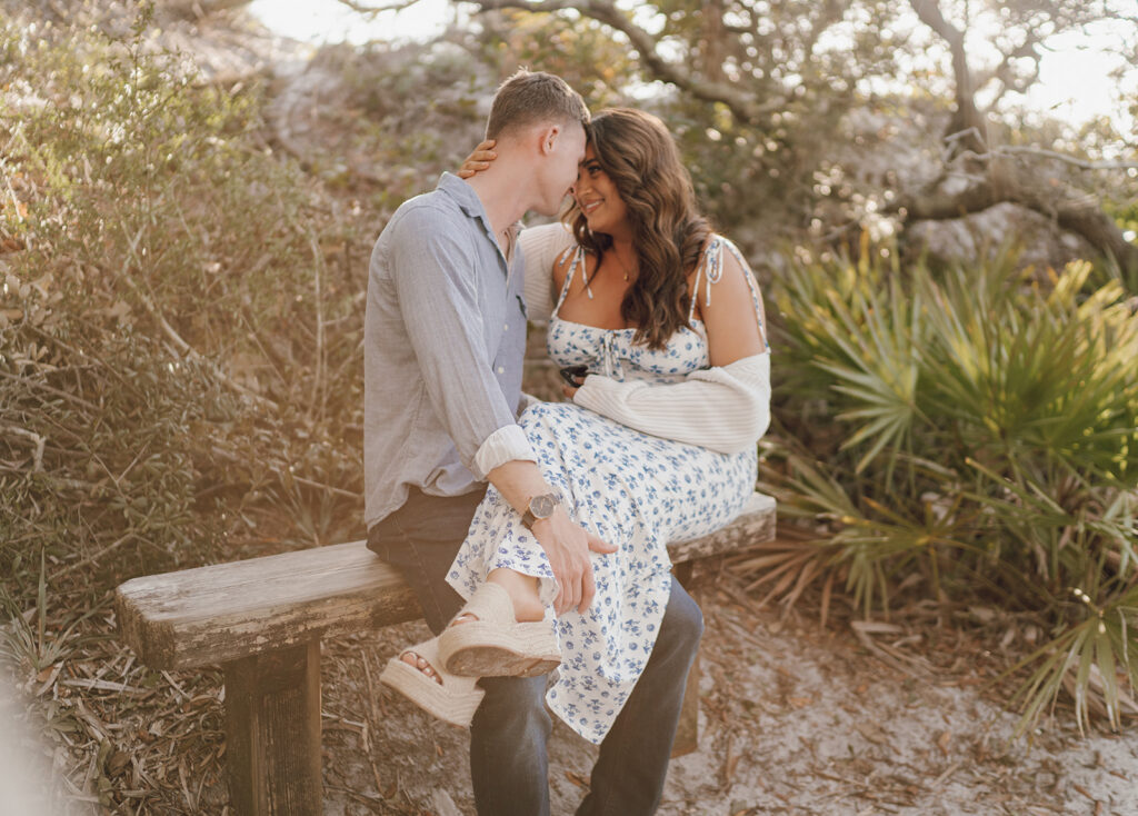 couple smiling and touching foreheads playful maternity photos