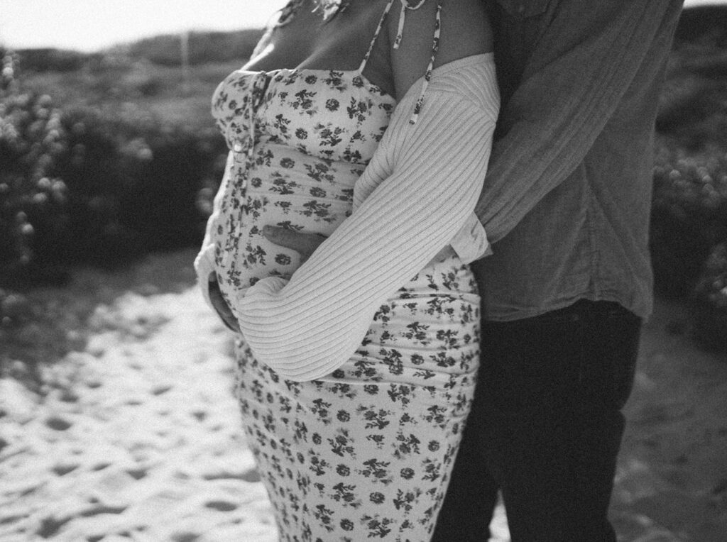 black and white gender reveal photos on the beach
