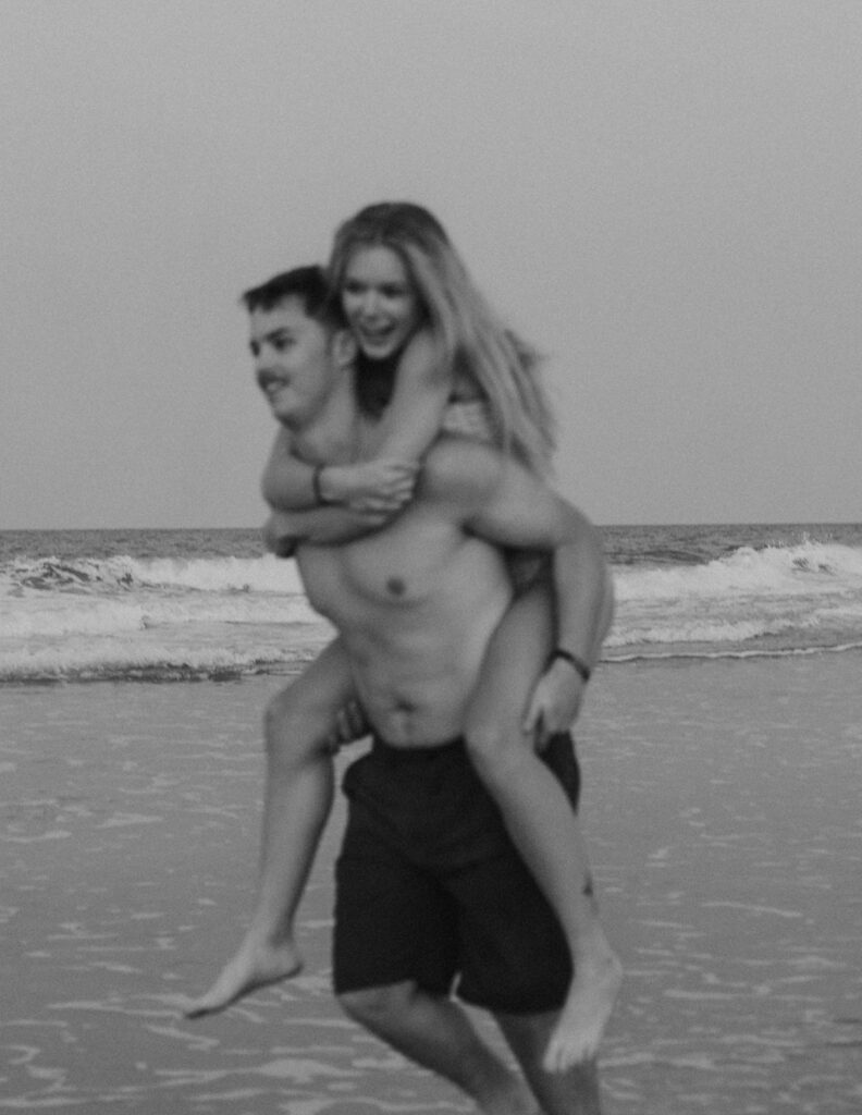 blurry candid engagement photos on the beach