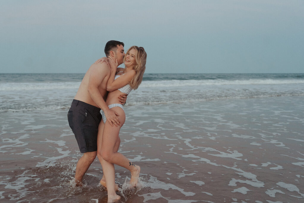 playful couple photos on daytona beach in florida
