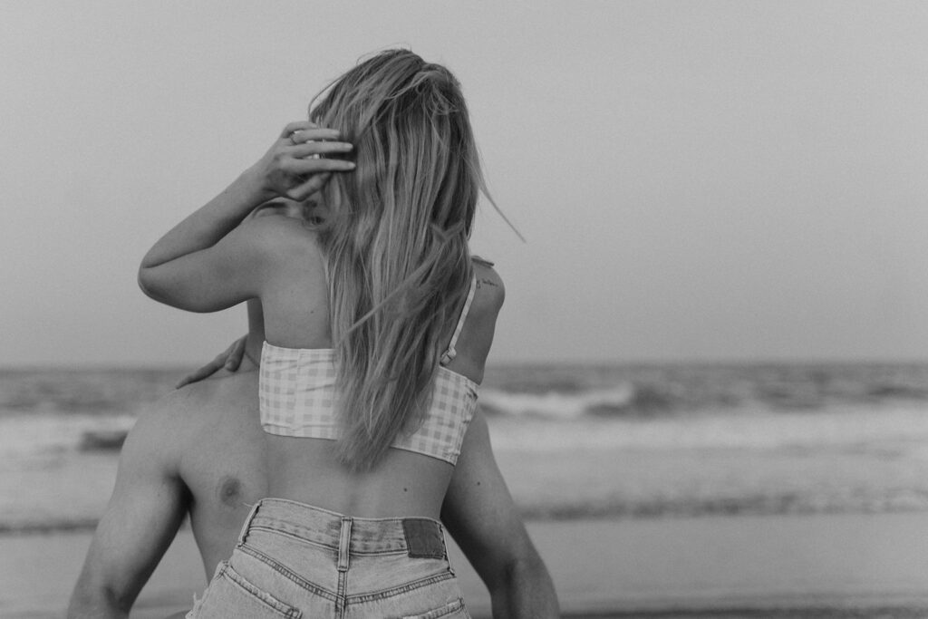 unique black and white engagement photos on the beach
