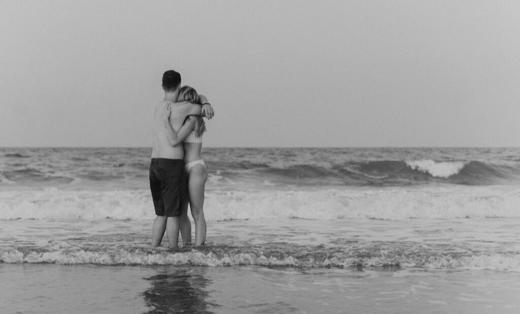 couple standing in the ocean and hugging Daytona Photographer