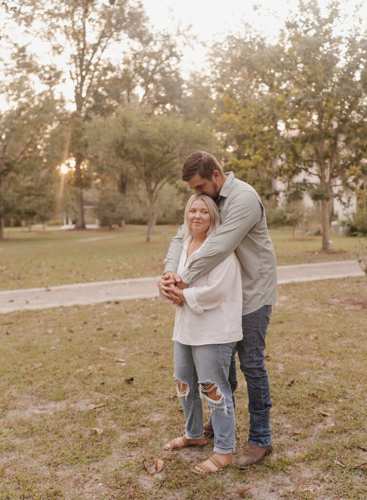 couple hugging and smiling during florida engagement session