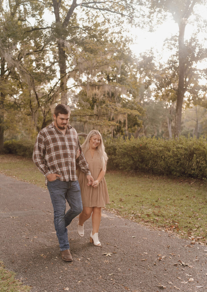 couple holding hands and walking in wakulla springs florida