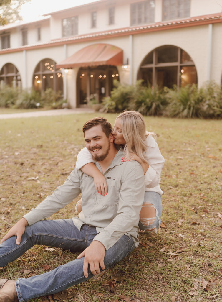 couple smiling candid poses for engagement photos in florida