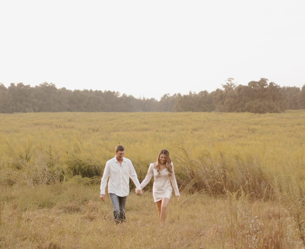 couple holding hands and walking during florida engagement session