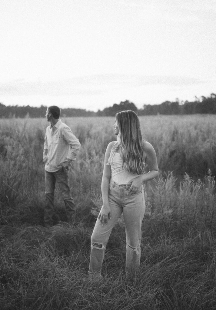 black and white engagement photos couple looking off into the distance
