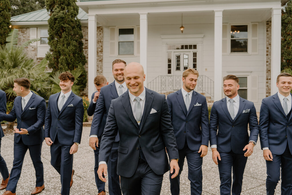 groomsmen walking and smiling charleston photographer