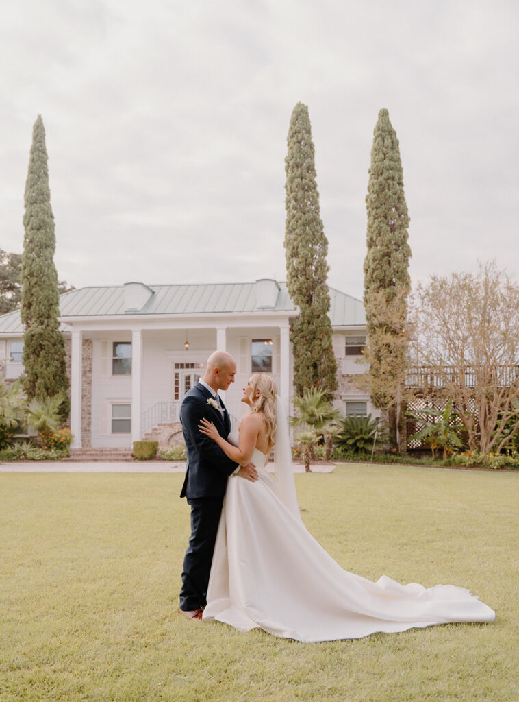 bride and groom standing in front of charleston wedding venue