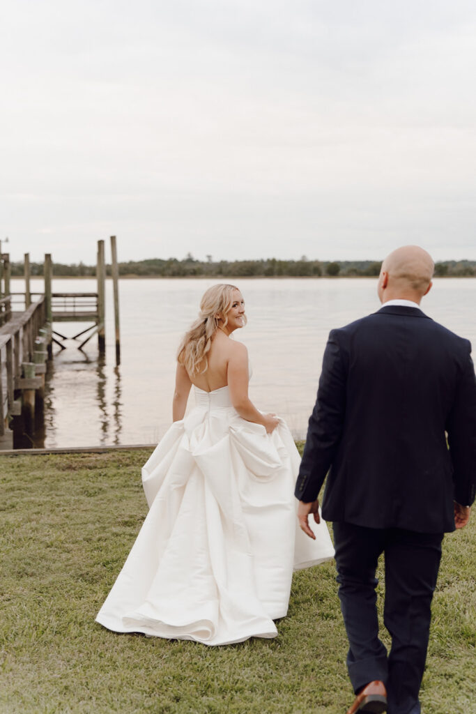 bride and groom portraits in front of riverfront