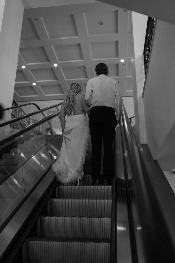 couple holding hands on escalator session