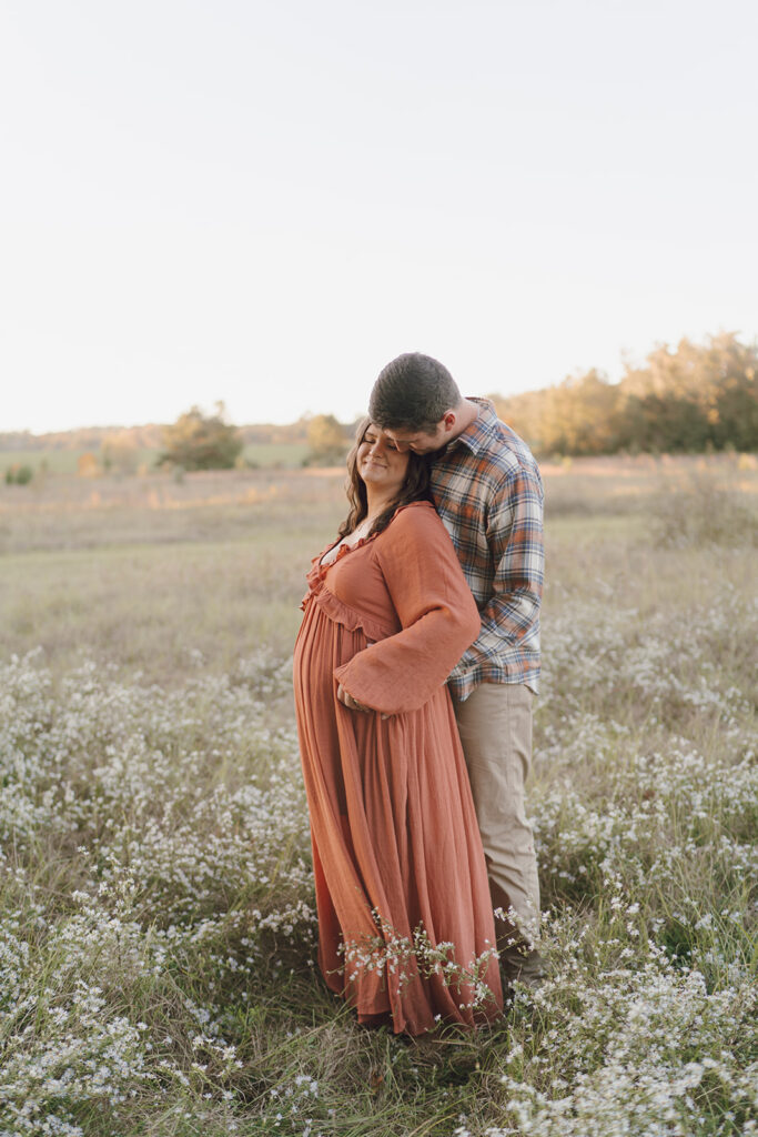 field maternity photos with wildflowers