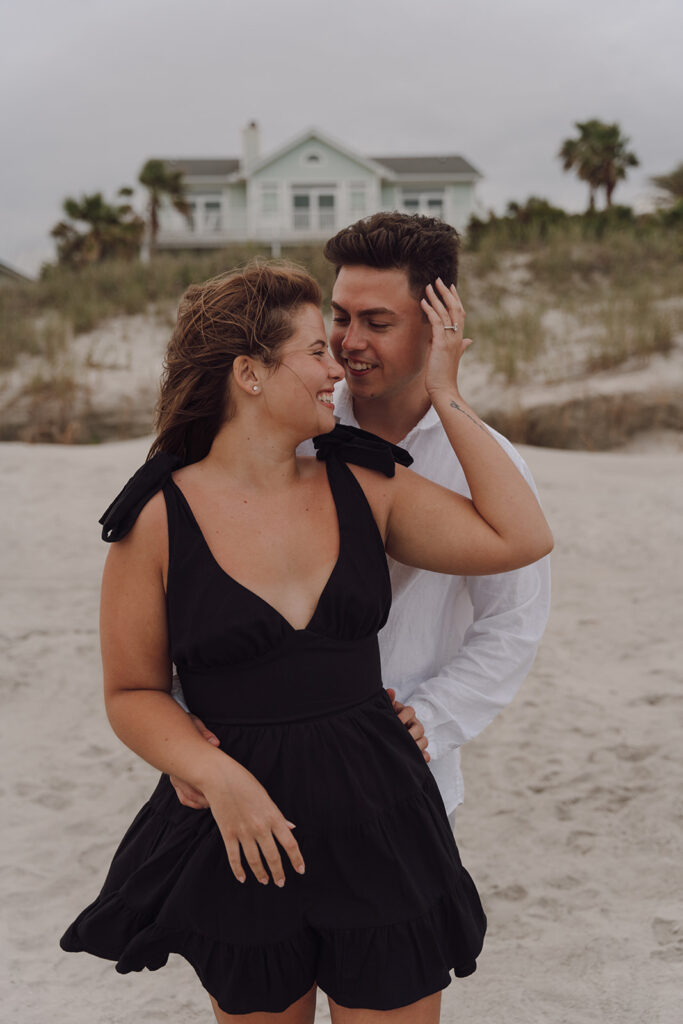 playful couple poses for engagement photos in charleston