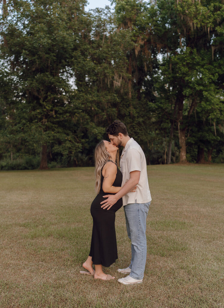 maternity session in tallahassee florida couple kissing pose