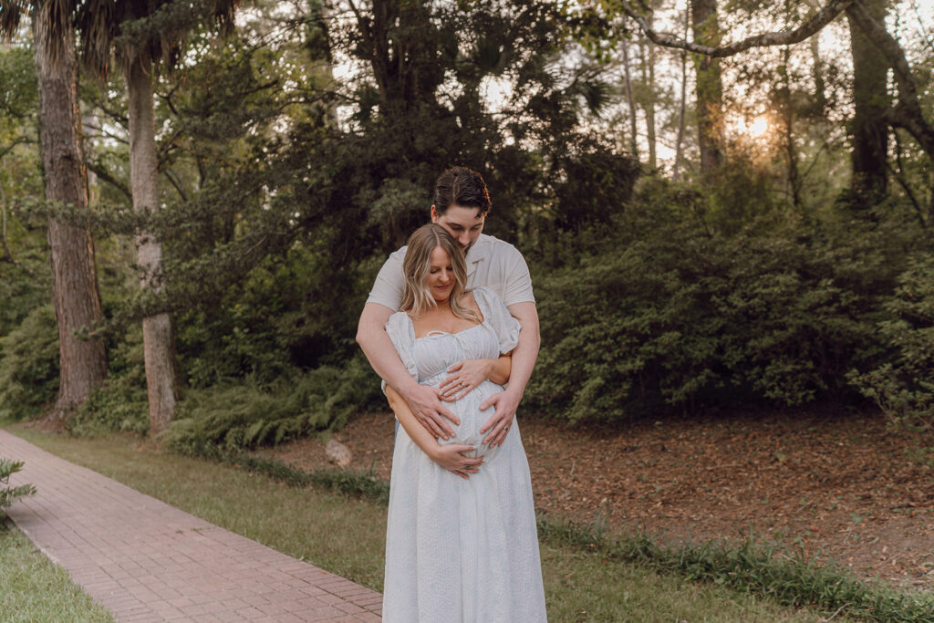 hug from behind maternity pose outdoors florida session