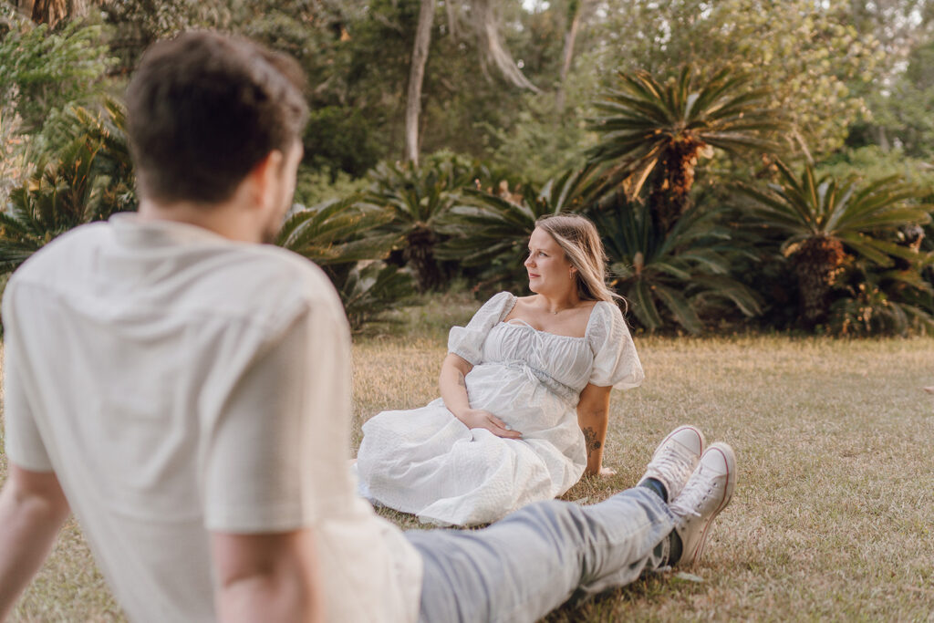 couple laying on the grass in florida during couples photoshoot