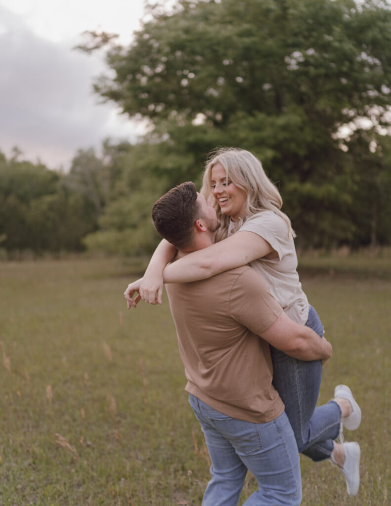 couple lift pose smiling and laughing candid photos