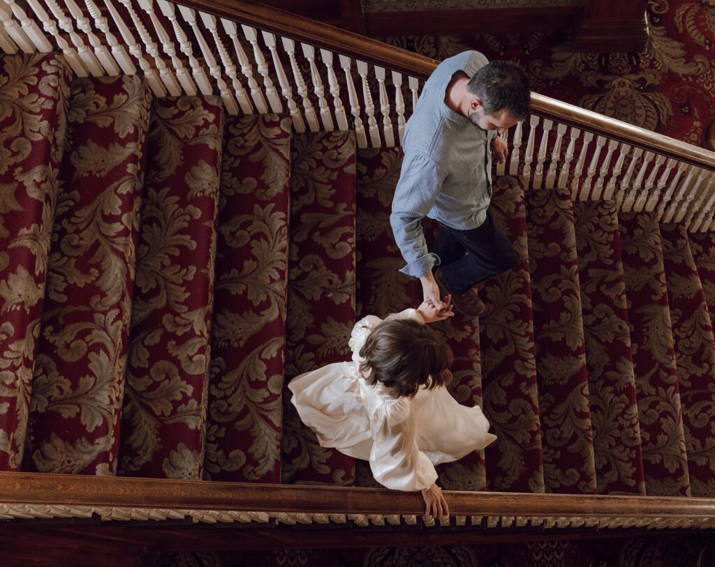 bride and groom walking down the stairs of the stanley hotel