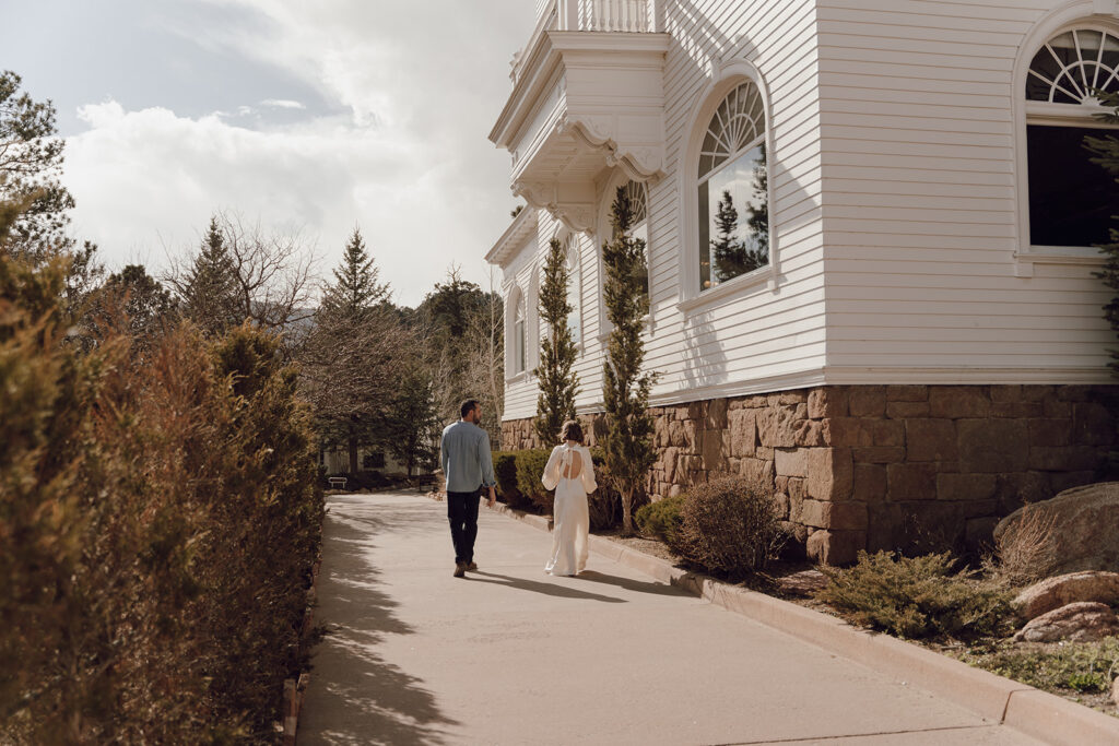 bride and groom walking around the stanley hotel