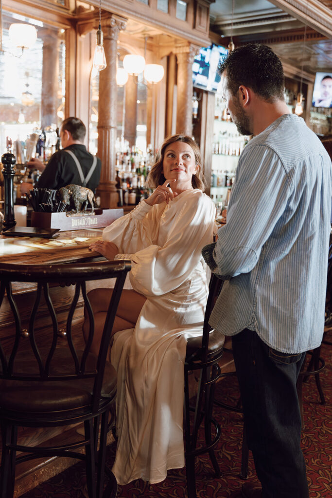 bride and groom getting drinks at the bar