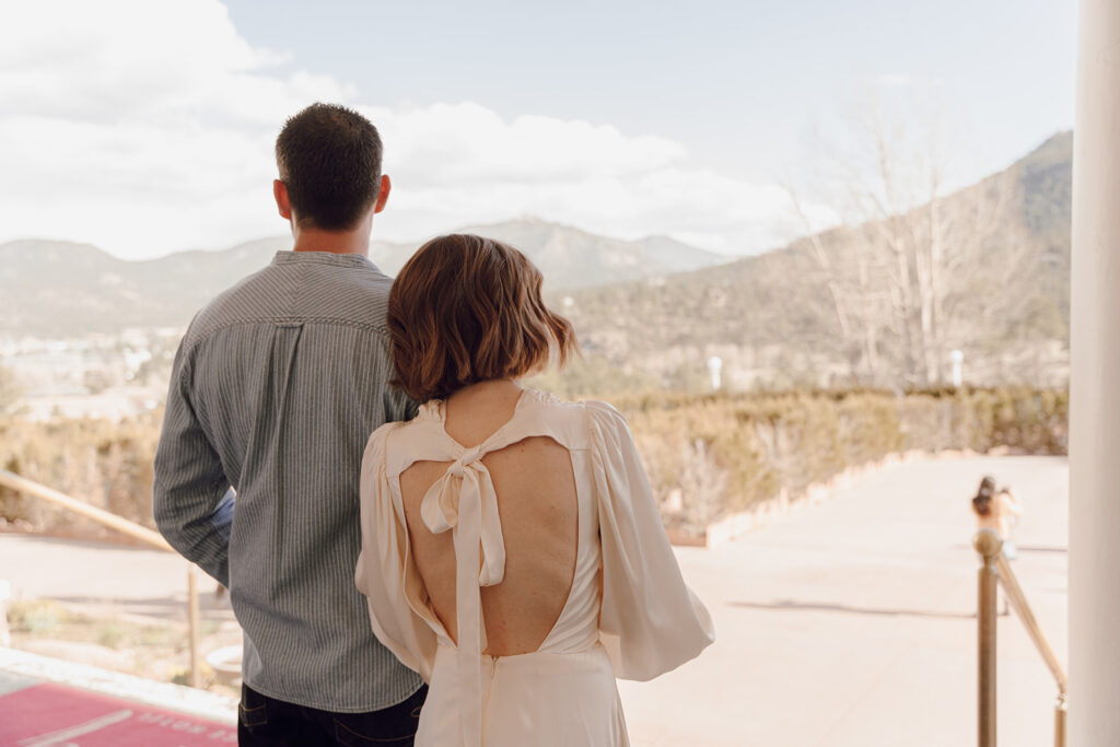 bride and groom looking out into the mountains in colorado