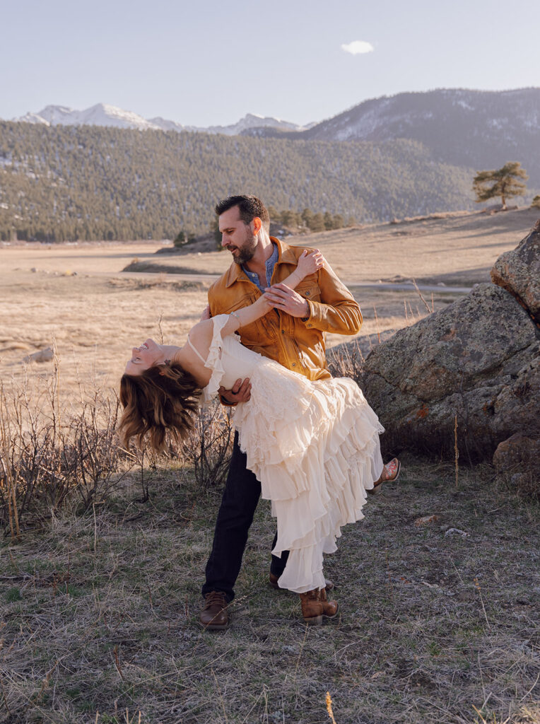 dip pose with bride and groom in the mountains