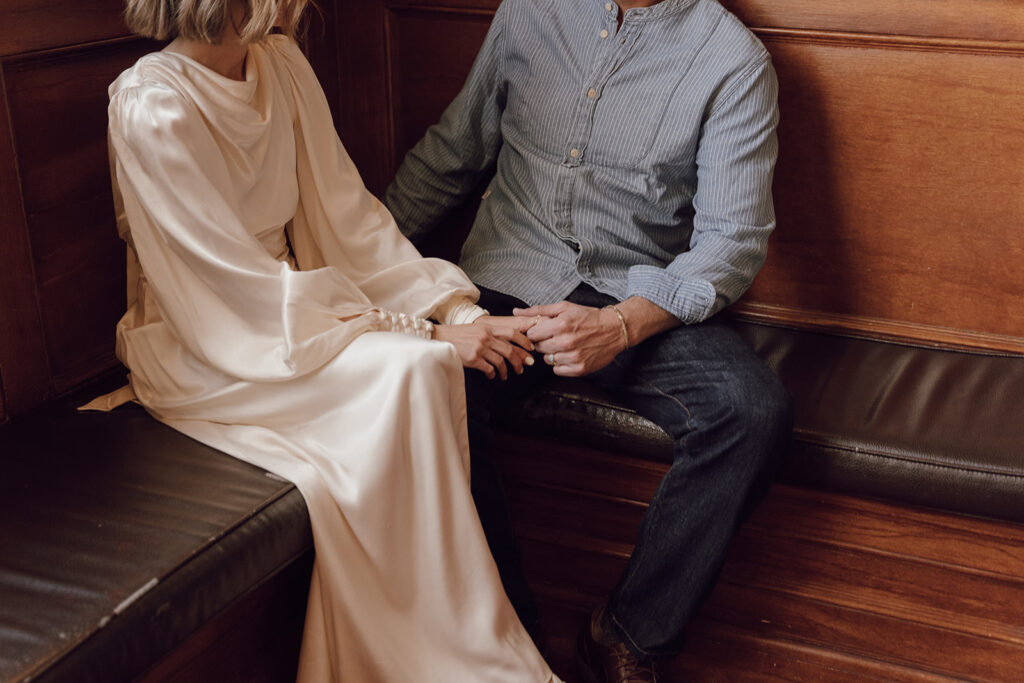 bride and groom holding hands getting ready wedding photos