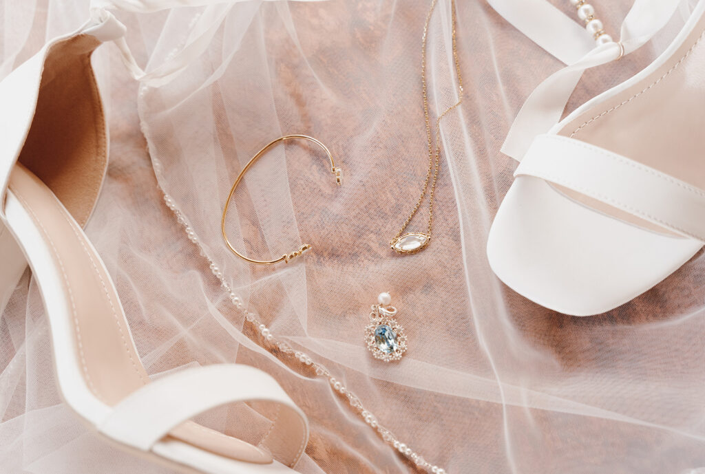 wedding details flatlay ring veil and wedding shoes