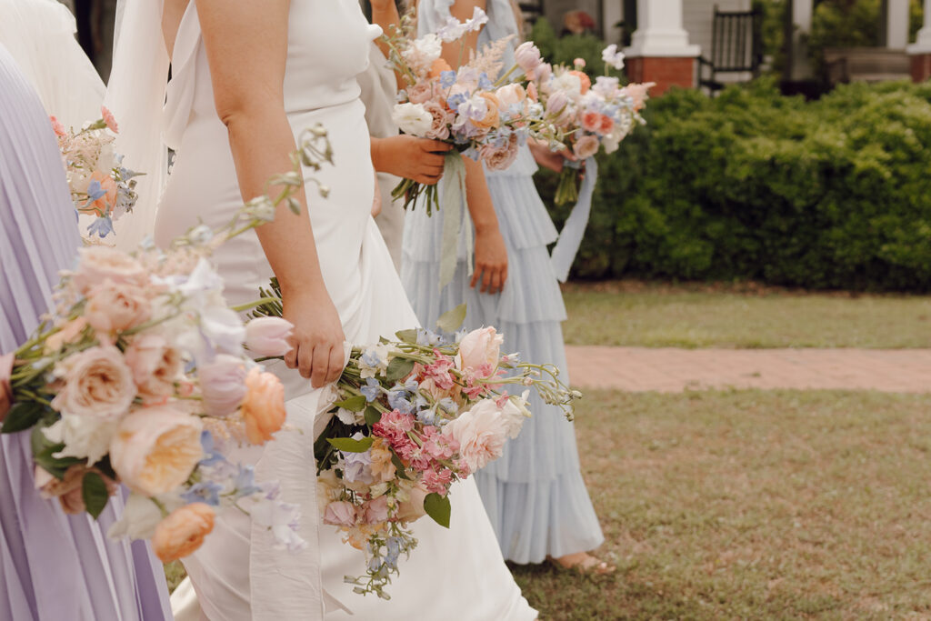 bride walking with bridesmaids spring wedding florals and spring wedding dresses