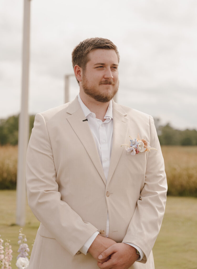 groom watching bride walk down the aisle