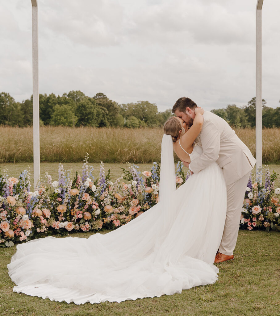 bride and groom kissing after wedding ceremony