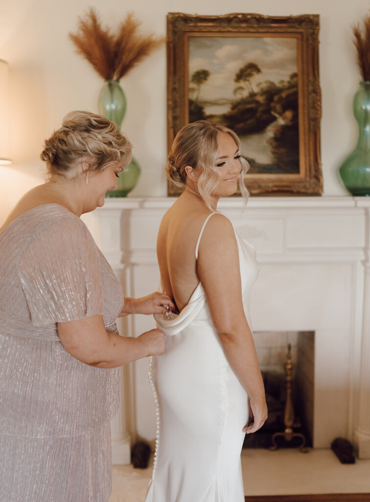 bride getting ready wedding photos with mom