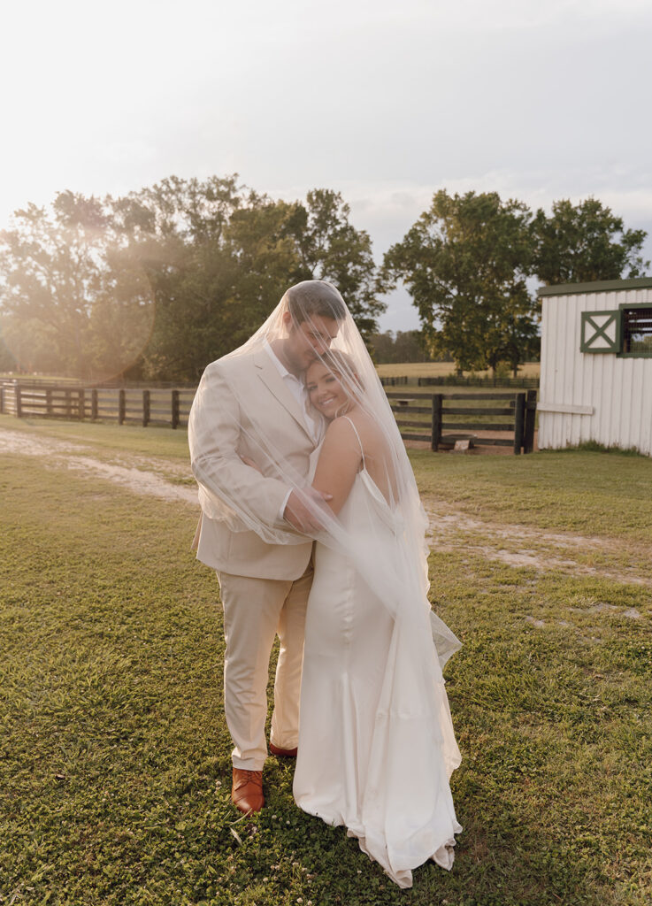 bride and groom under veil photos