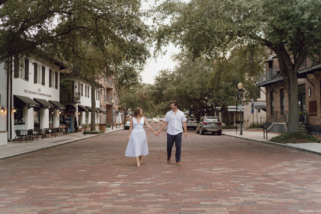 couple holding hands and walking on the street