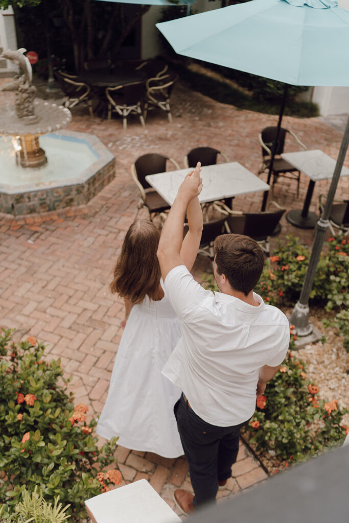 couple spinning pose for orlando engagement photos