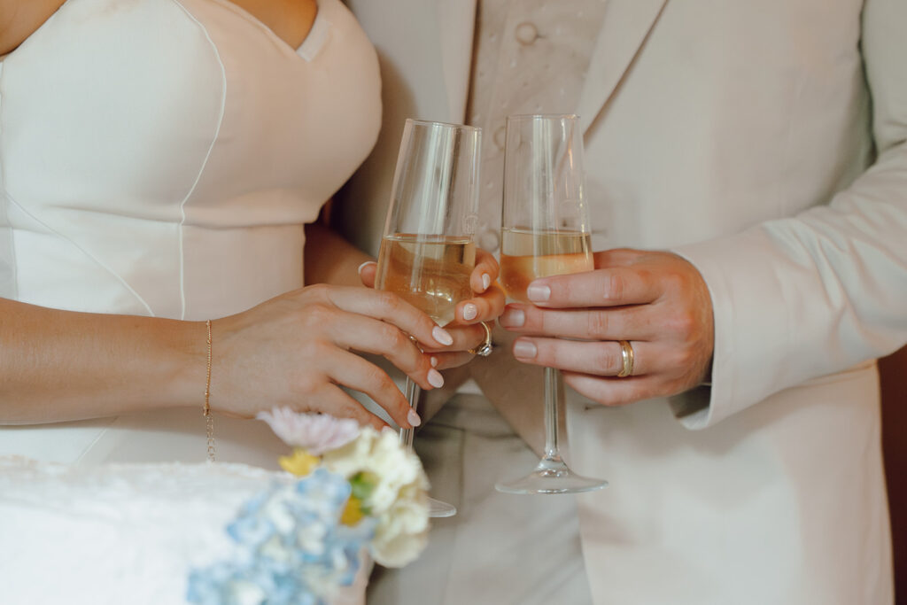 bride and groom drinking champagne