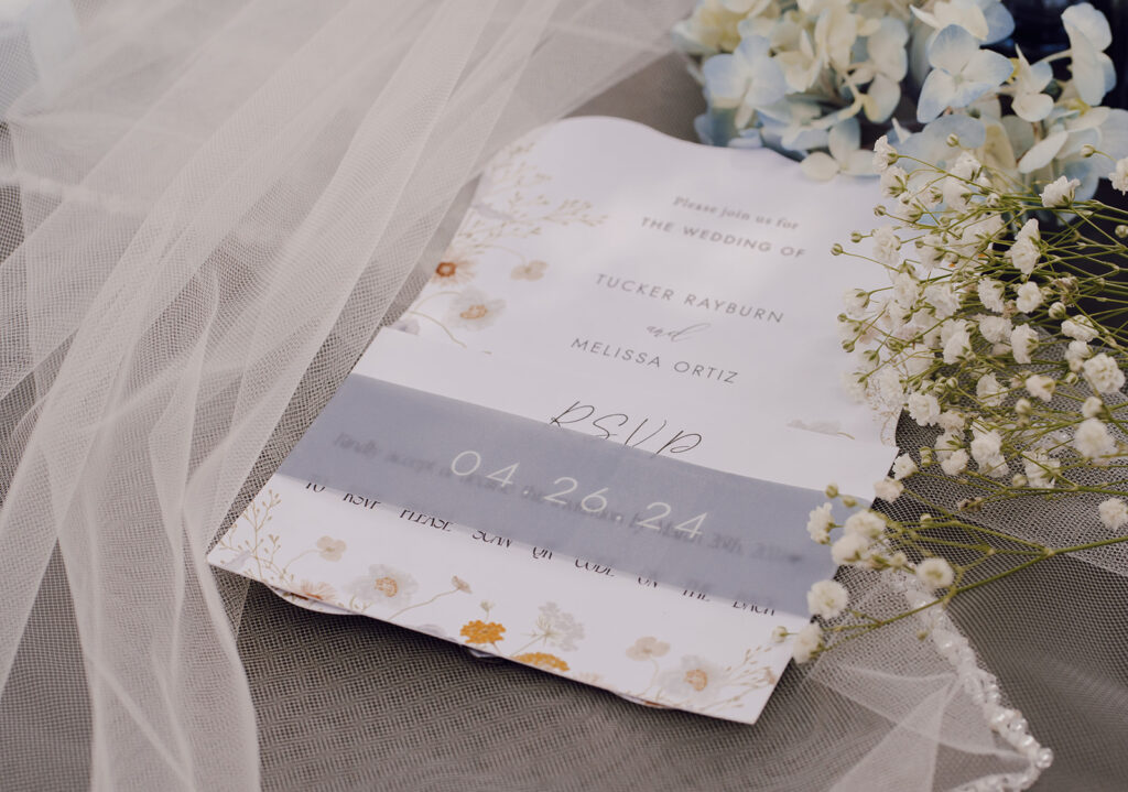 wedding invites on top of veil