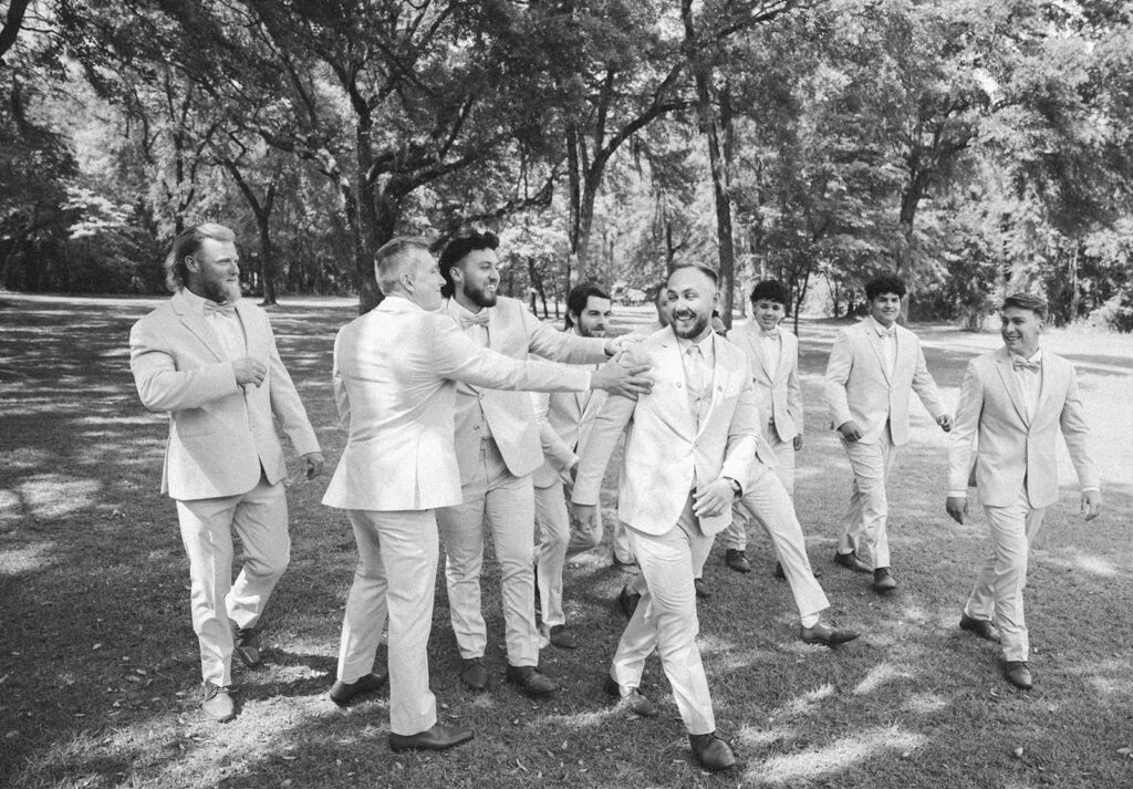 candid black and white groomsmen photos