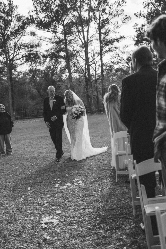 dad walking daughter down the aisle for outdoor wedding ceremony