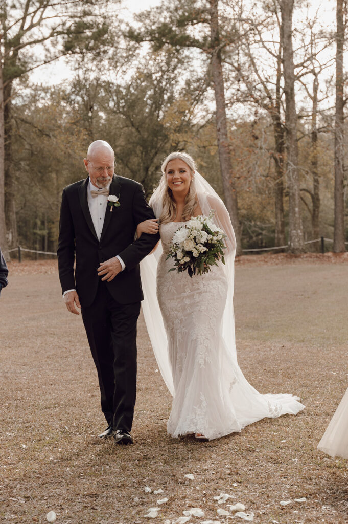 dad walking daughter down the aisle for outdoor wedding ceremony