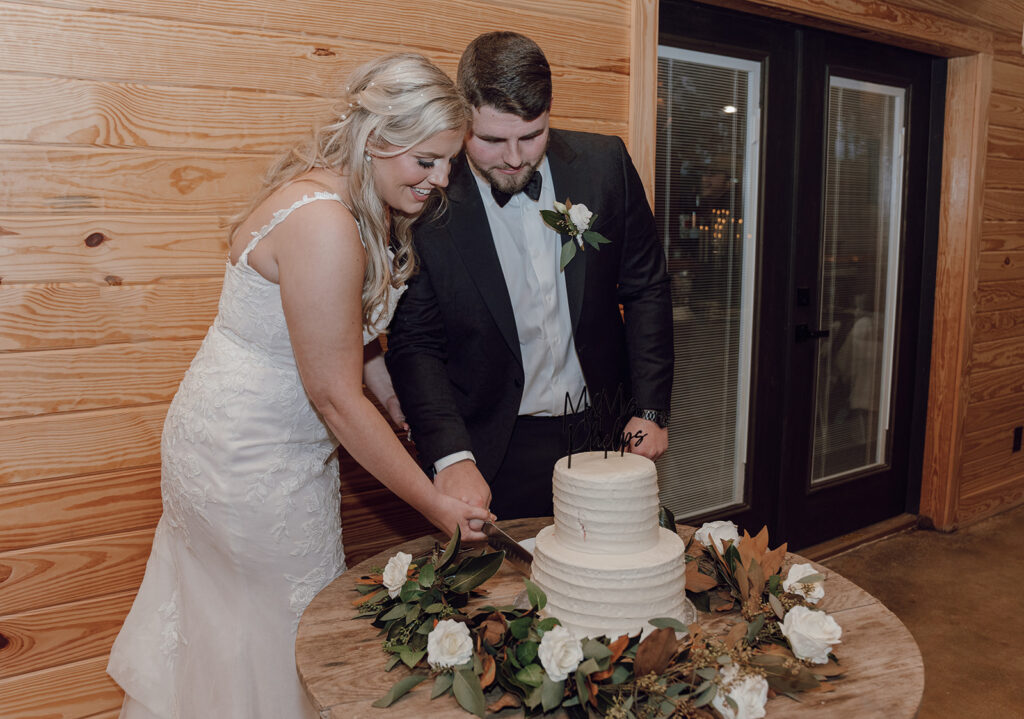 bride and groom cutting wedding cake