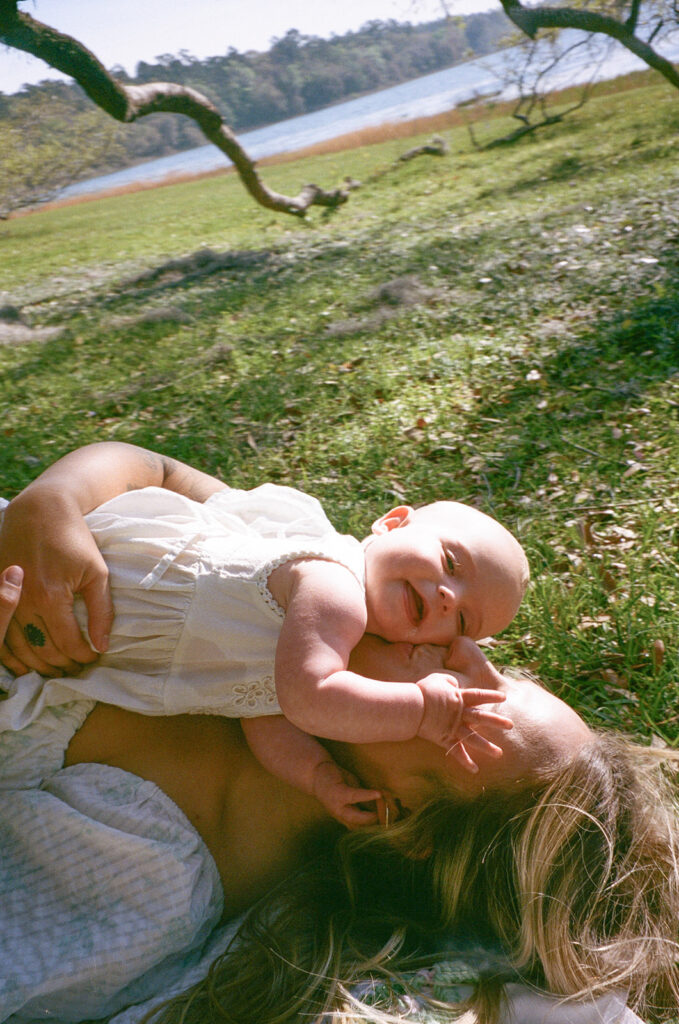 mom and baby smiling on a picnic blanket in Tallahassee